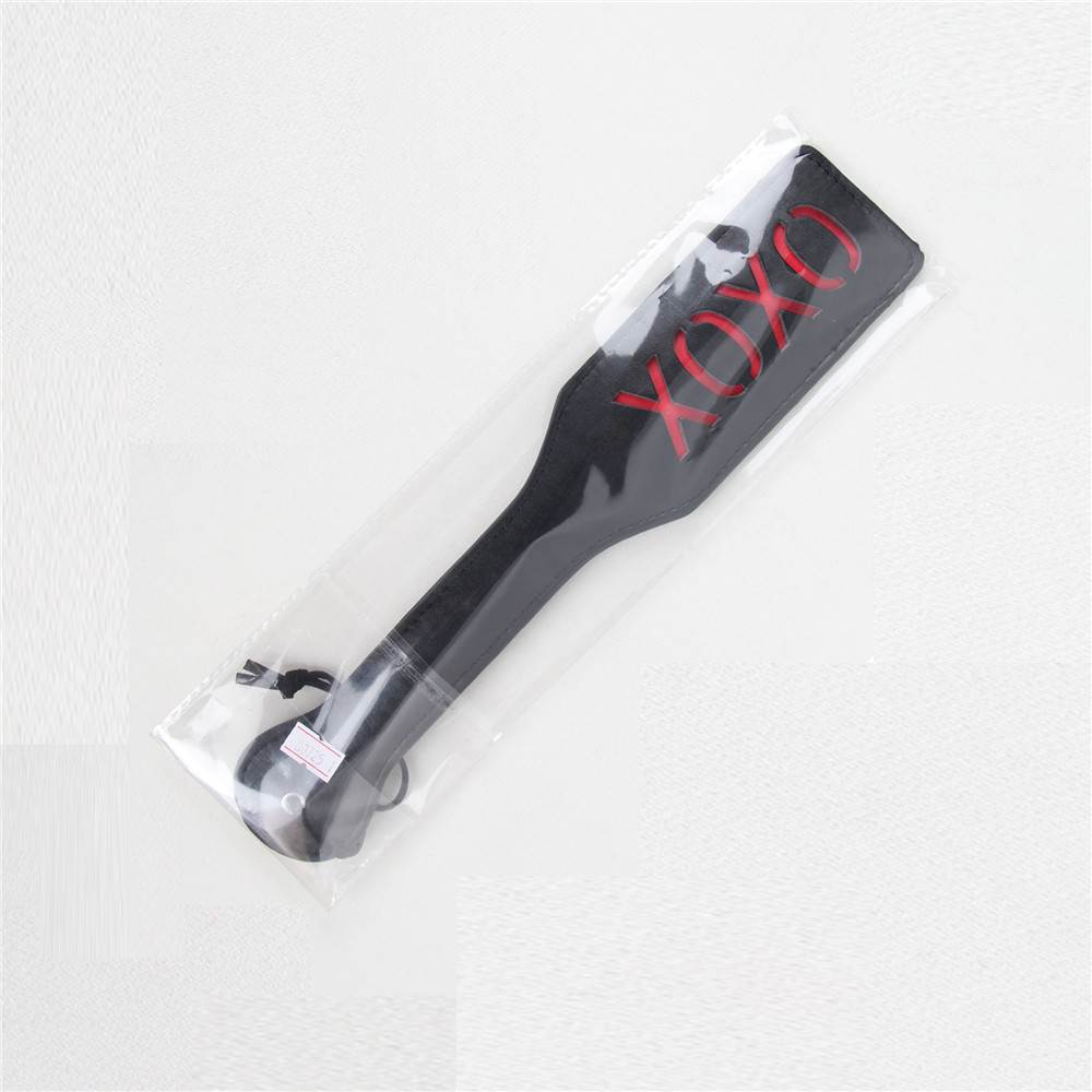 Packaged black and red BDSM whip